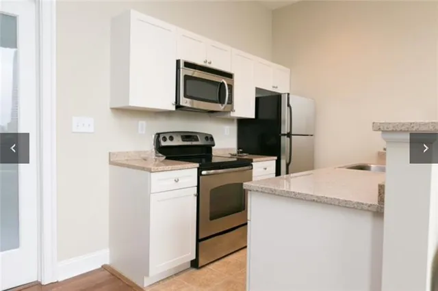 a kitchen with a sink stove and refrigerator