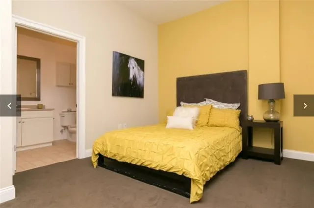 a bedroom with a bed and night stand