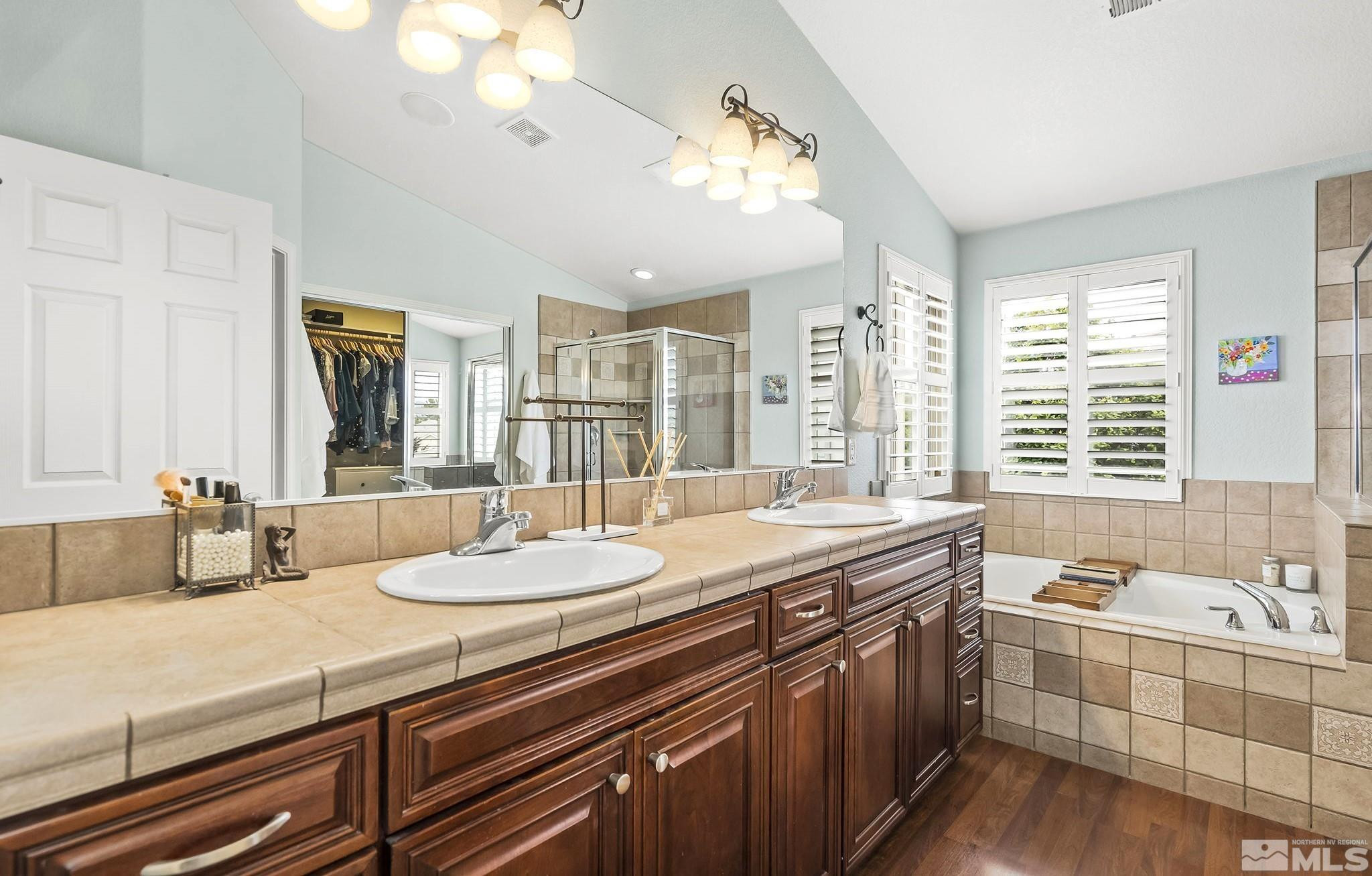 10031 Cascade Falls Drive Reno, NV 89521 - Photo 15 of 30 a bathroom with a granite countertop sink and a large mirror