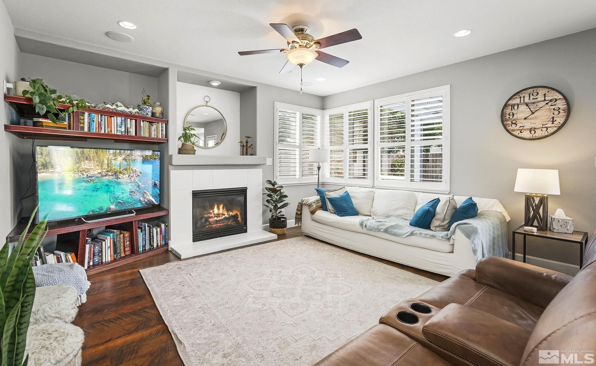 10031 Cascade Falls Drive Reno, NV 89521 - Photo 2 of 30 a living room with furniture a window and a fireplace