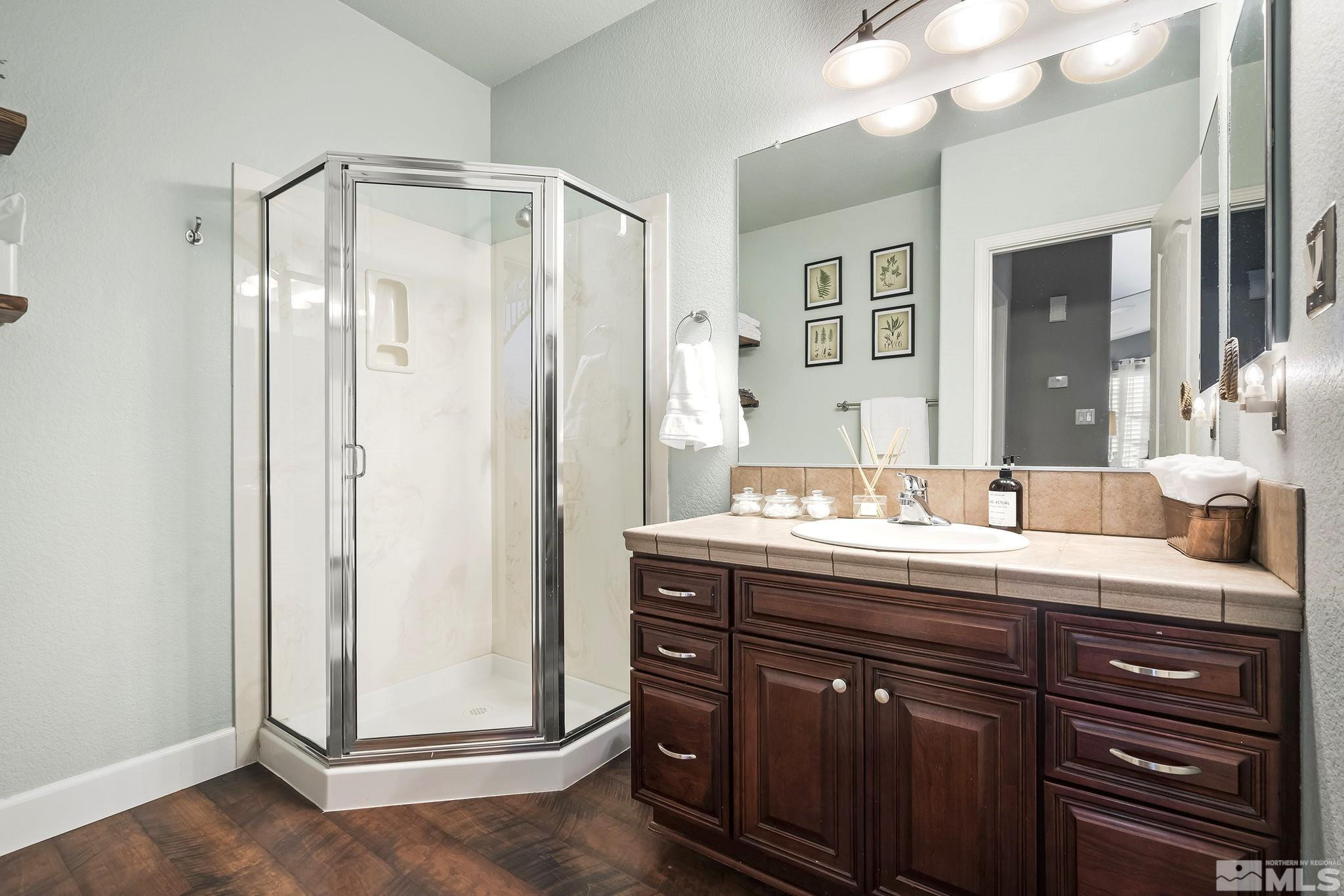 10031 Cascade Falls Drive Reno, NV 89521 - Photo 21 of 30 a bathroom with a granite countertop sink and a mirror