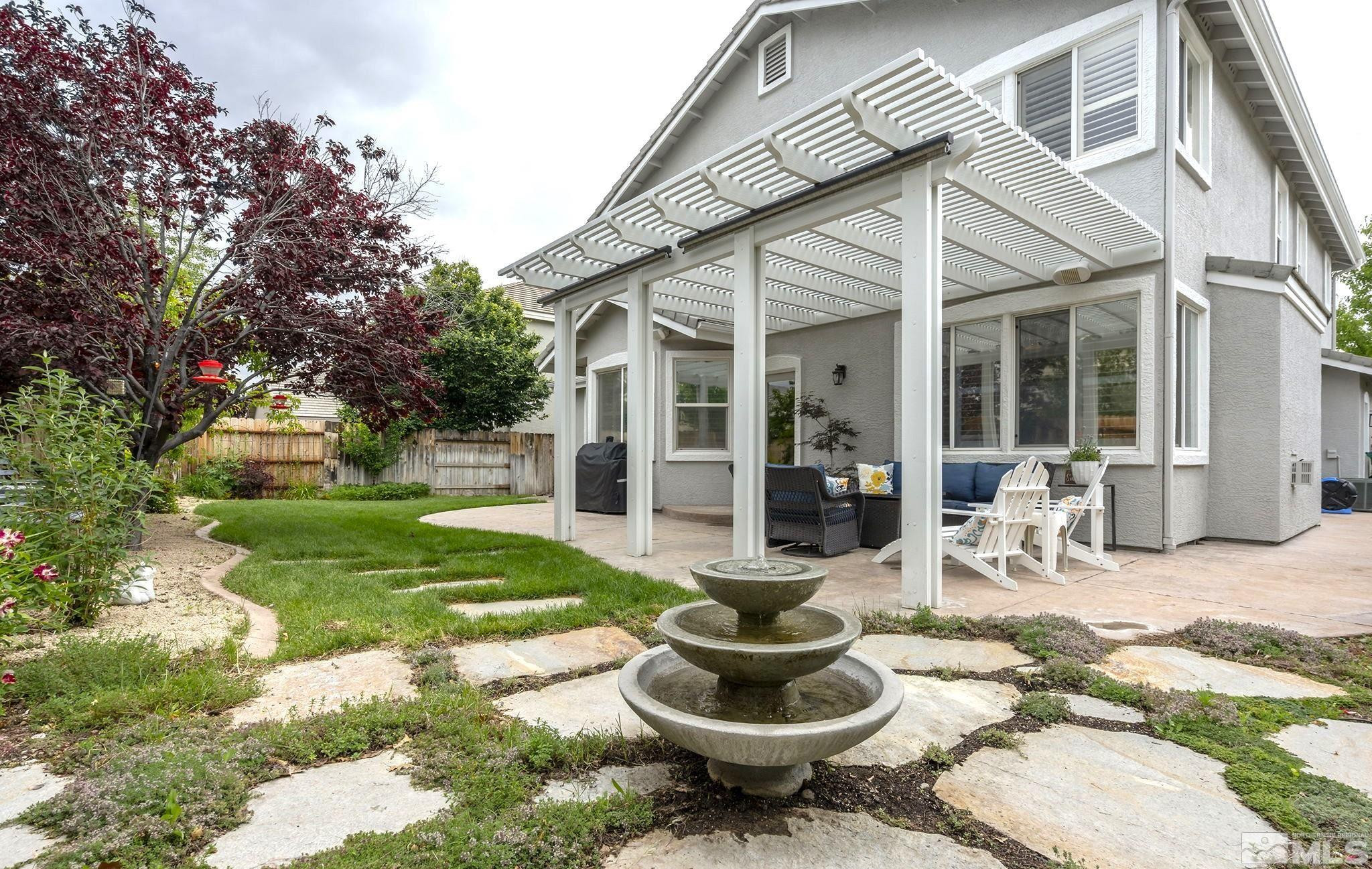 10031 Cascade Falls Drive Reno, NV 89521 - Photo 24 of 30 a outdoor space with a patio and a garden