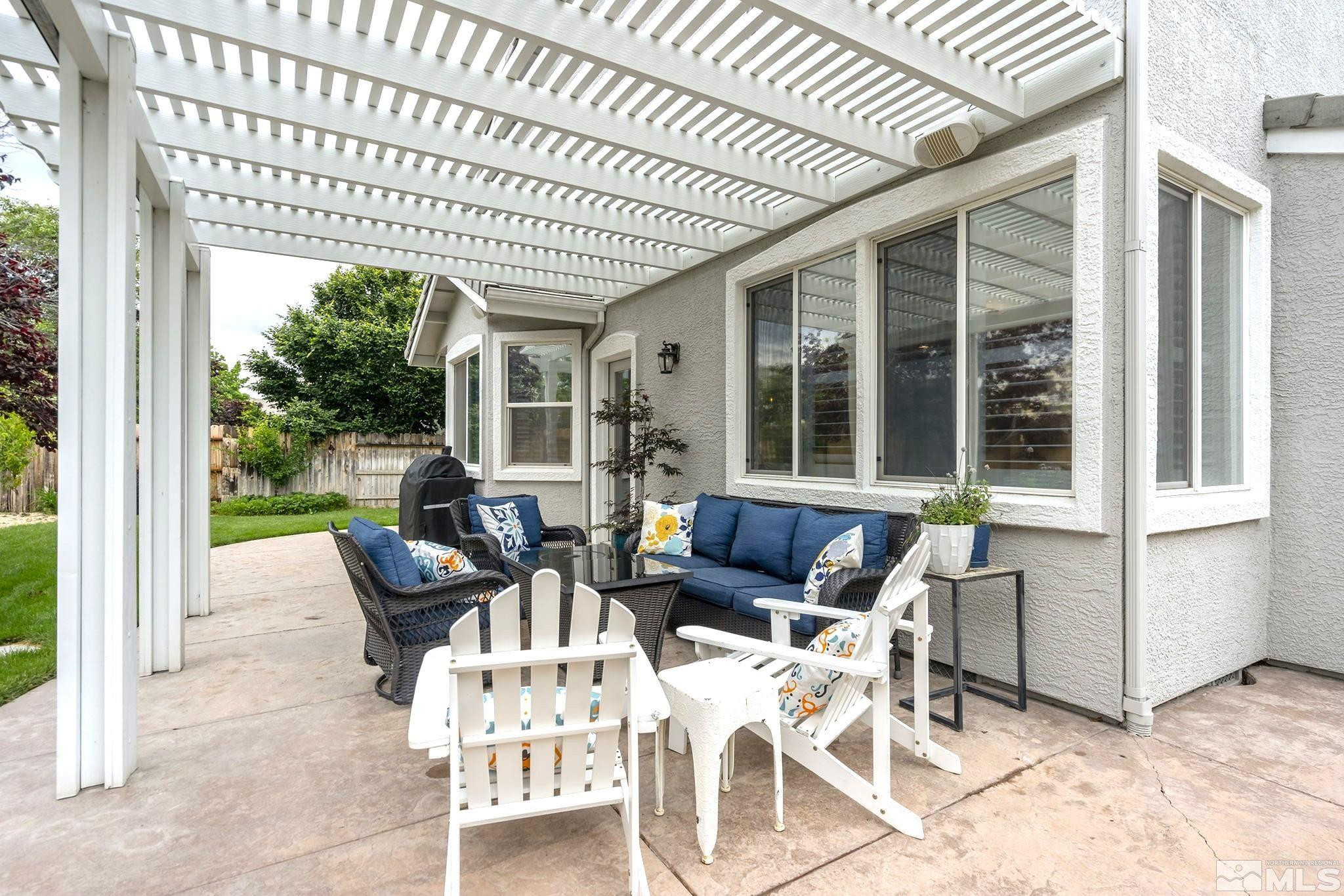 10031 Cascade Falls Drive Reno, NV 89521 - Photo 28 of 30 a view of a patio with couches table and chairs and potted plants