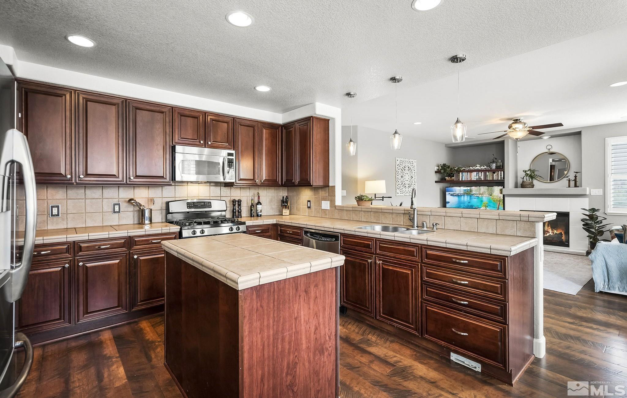 10031 Cascade Falls Drive Reno, NV 89521 - Photo 5 of 30 a kitchen with a sink stove and cabinets
