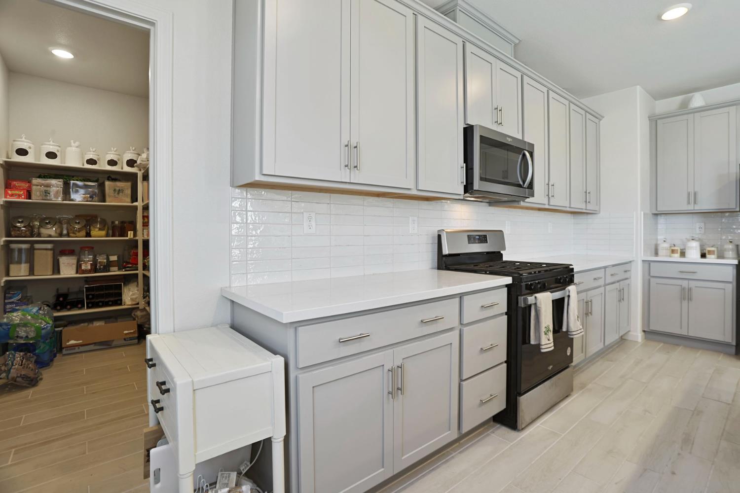 6949 Foraker Drive Stockton, CA 95219 - Photo 18 of 34 a kitchen with white cabinets and white appliances