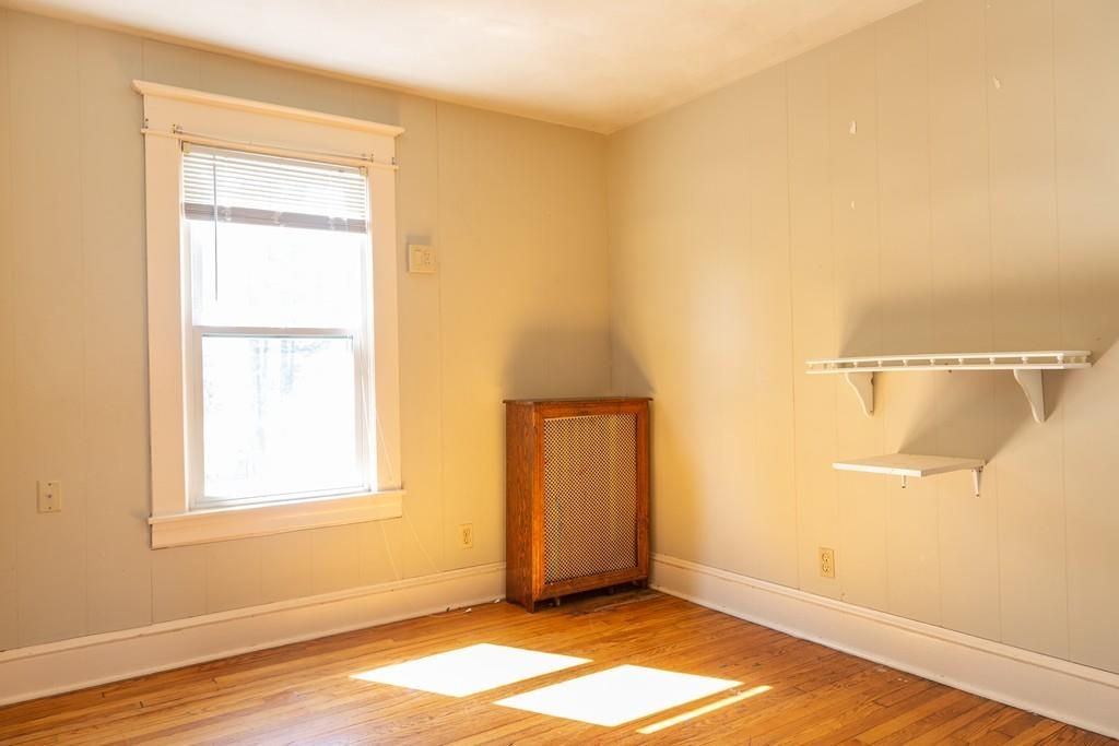 116 Jenness Street Springfield, MA 01104 - Photo 24 of 42 a view of an empty room with wooden floor and a window