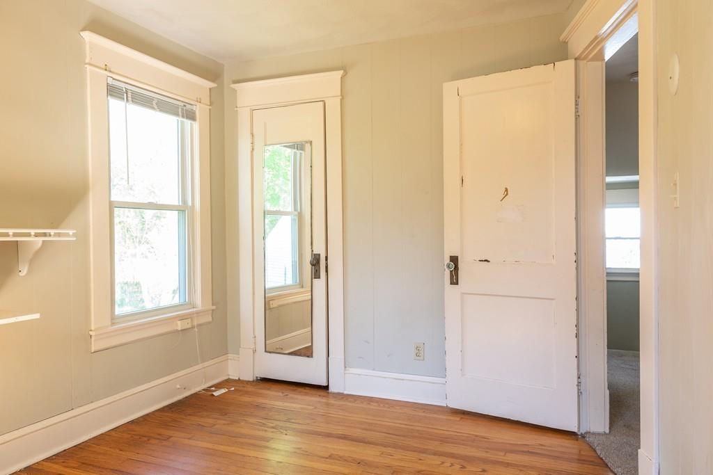 116 Jenness Street Springfield, MA 01104 - Photo 27 of 42 a view of an empty room with wooden floor and a window