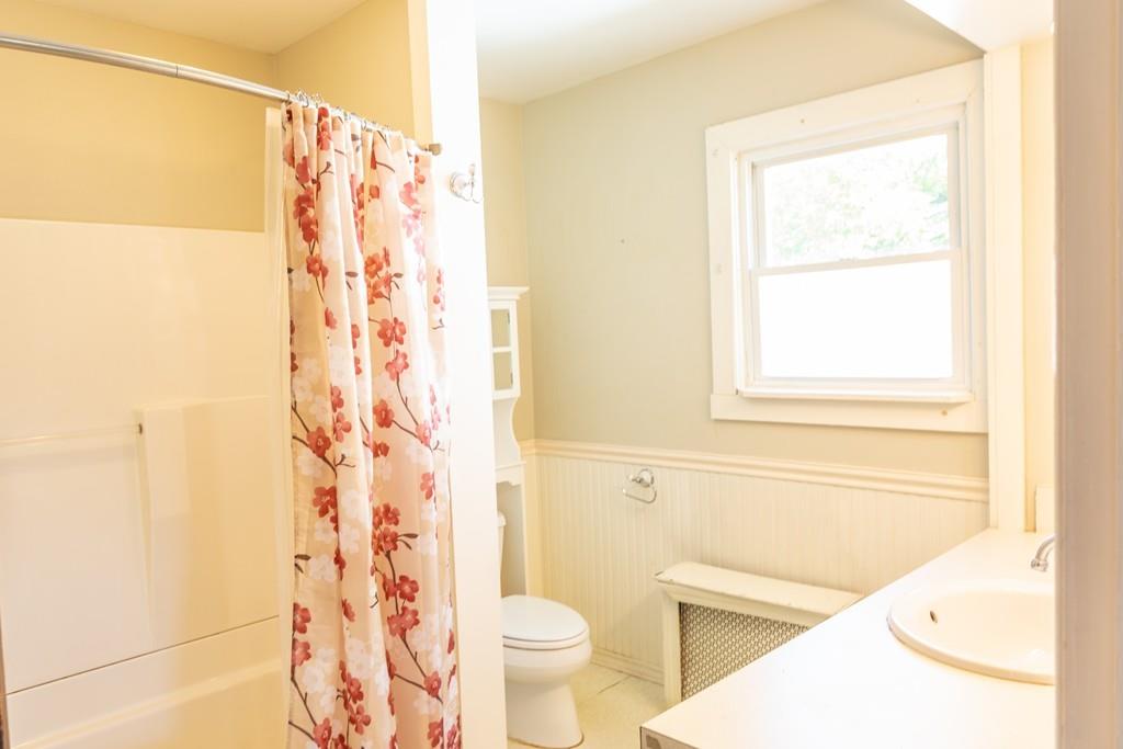 116 Jenness Street Springfield, MA 01104 - Photo 28 of 42 a bathroom with a toilet and a shower curtain