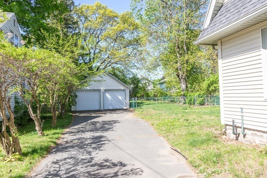 116 Jenness Street Springfield, MA 01104 - Photo 34 of 42 a backyard of a house with large trees and wooden fence