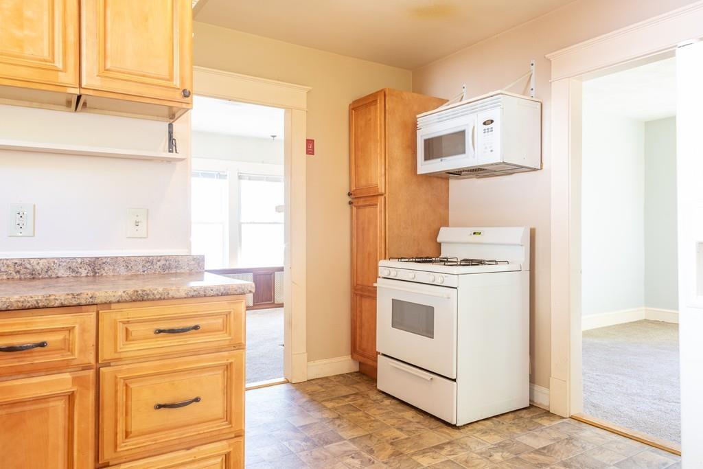 116 Jenness Street Springfield, MA 01104 - Photo 4 of 42 a kitchen with granite countertop cabinets and white appliances
