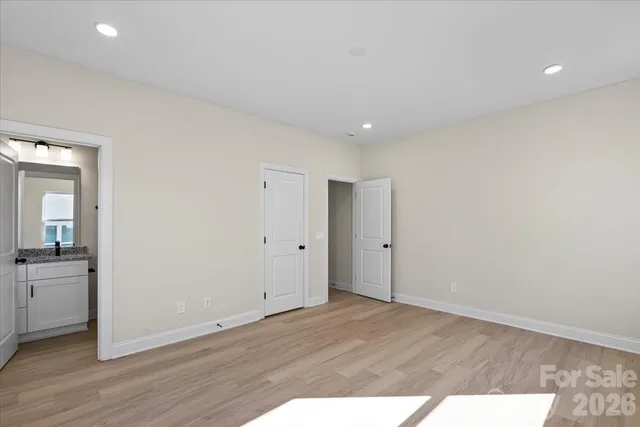 a view of an empty room and wooden floor