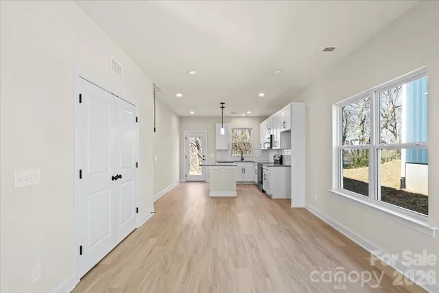 a view of a kitchen with wooden floor