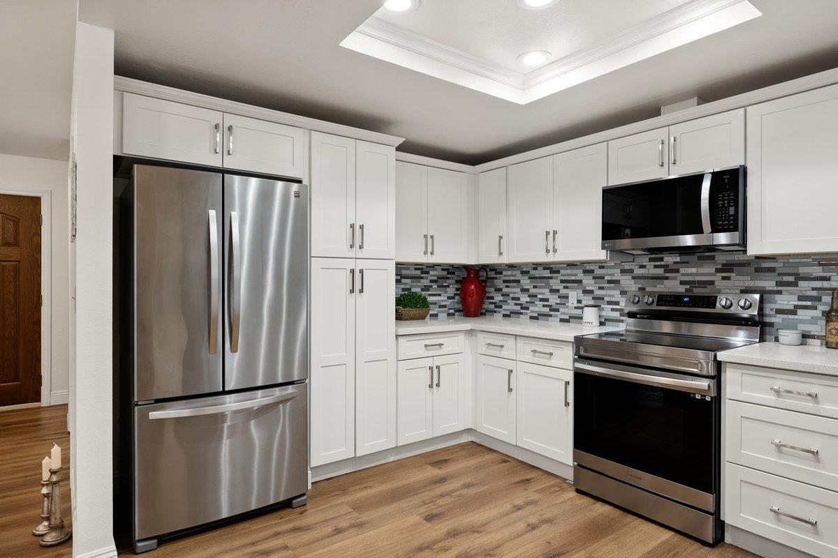 6561 Trinity Way Placerville, CA 95667 - Photo 31 of 58 a kitchen with a refrigerator stove and microwave