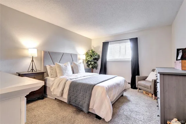 a bedroom with a bed and a table in it