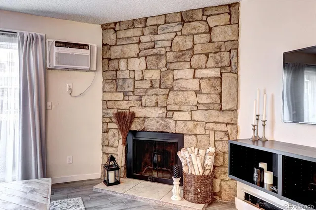 a kitchen with a fireplace and a window