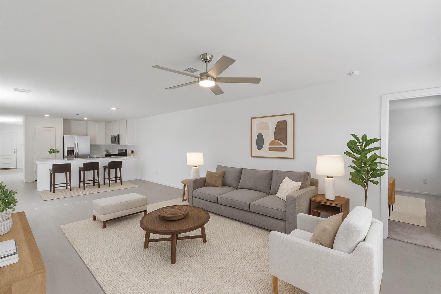 a living room with furniture a couch and a potted plant