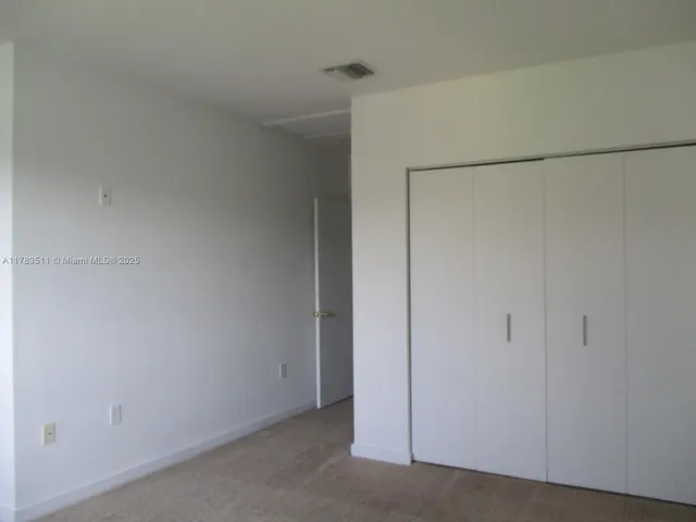 a bathroom with a granite countertop bathtub shower sink vanity and toilet