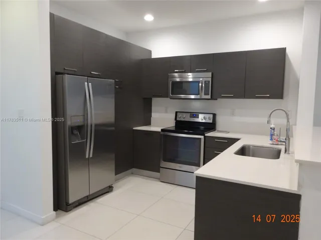 a kitchen with a refrigerator and a sink
