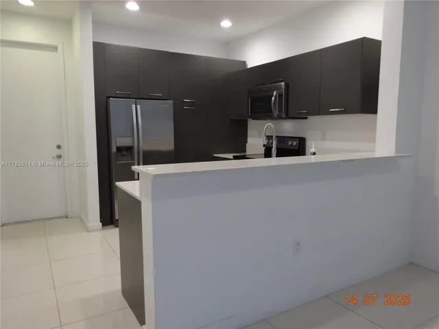 a view of a kitchen with a refrigerator