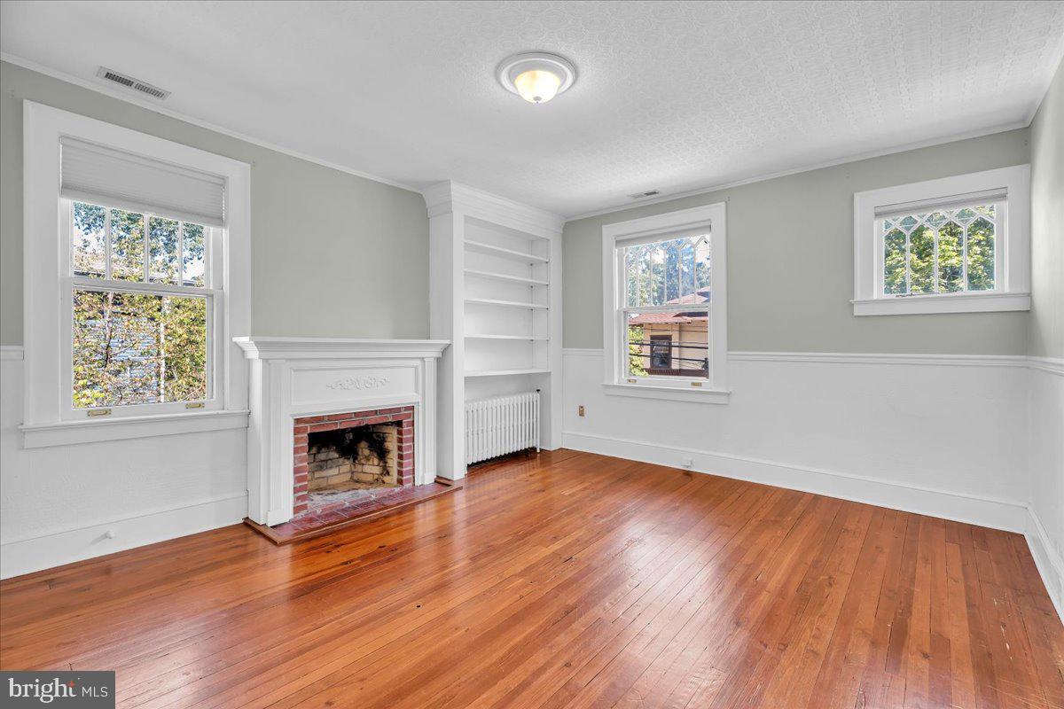 2 Evergreen Lane Haddonfield, NJ 08033 - Photo 19 of 25 an empty room with wooden floor a fireplace and windows