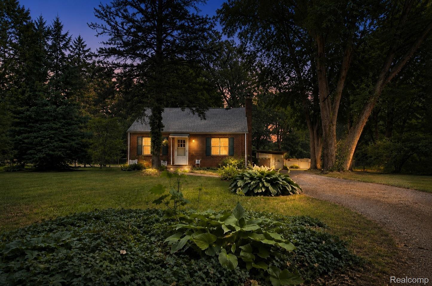9552 Wayne Road Livonia, MI 48150 - Photo 2 of 31 Brick facade residence featuring a front porch entry and illuminated windows