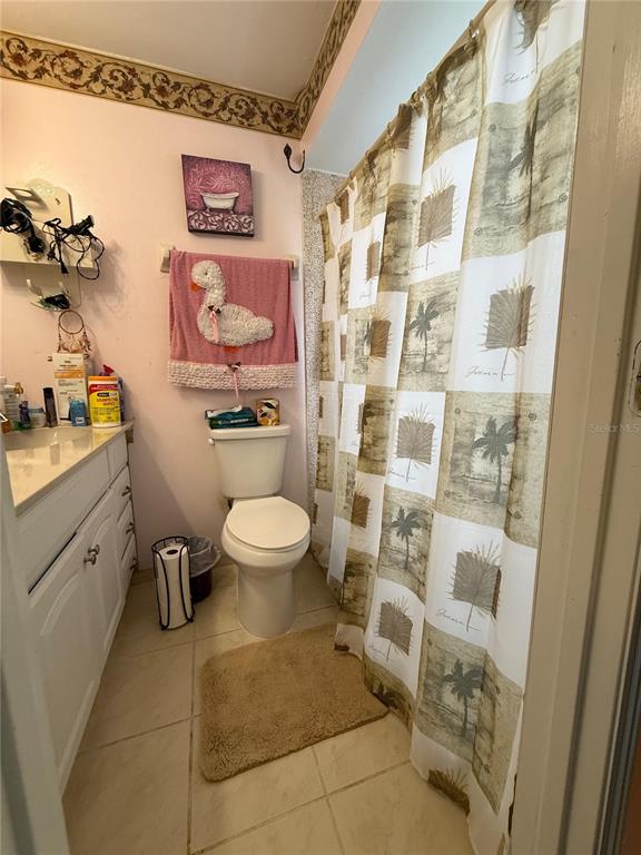 11308 Libby Road Spring Hill, FL 34609 - Photo 11 of 14 a bathroom with a toilet sink and shower