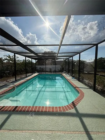 a view of a backyard with swimming pool