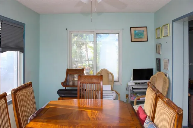 a view of a dining room with furniture a rug and wooden floor