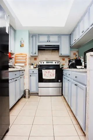 a kitchen with stainless steel appliances a stove sink and cabinets