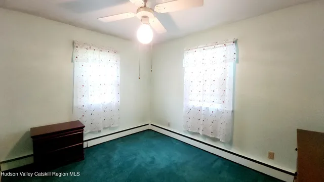 a room with a large window and mirror