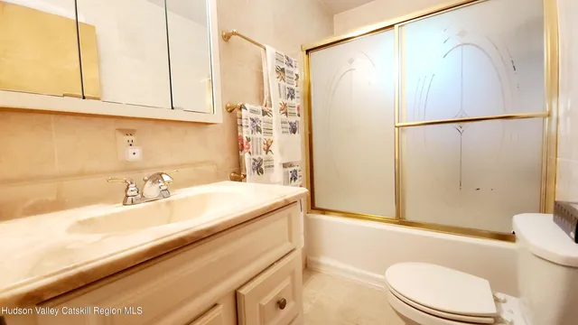 a bathroom with a shower toilet and sink