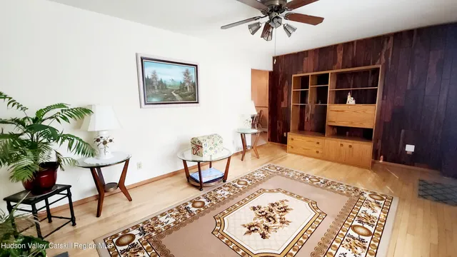 a living room with a rug and a window