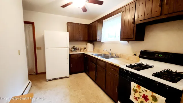 a kitchen with sink cabinets and appliances