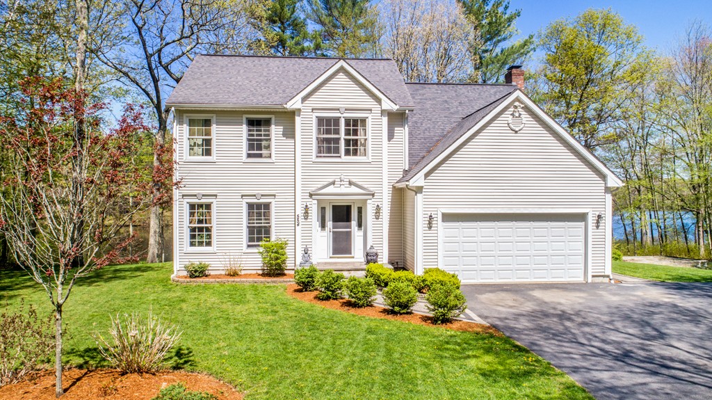 554 Douglas Road Northbridge, MA 01588 - Photo 1 of 30 a front view of a house with a garden and plants