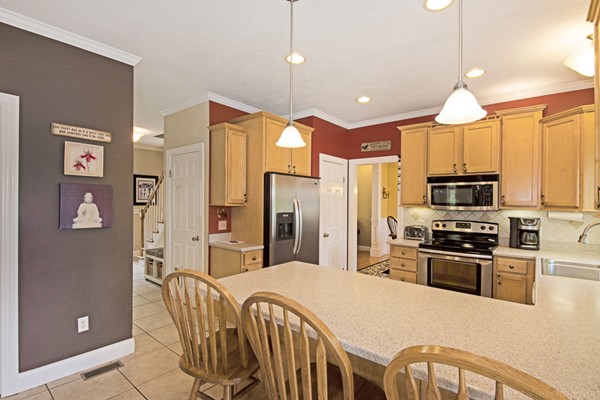 554 Douglas Road Northbridge, MA 01588 - Photo 15 of 30 a kitchen with stainless steel appliances granite countertop a refrigerator a stove a sink a microwave oven with cabinets and wooden floor