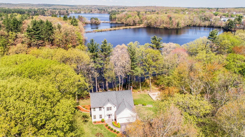554 Douglas Road Northbridge, MA 01588 - Photo 2 of 30 a view of a lake with a house in the background