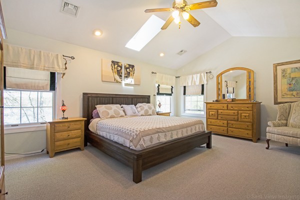 554 Douglas Road Northbridge, MA 01588 - Photo 21 of 30 a spacious bedroom with a bed and a chandelier