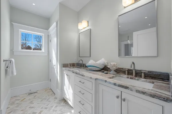 a bathroom with a granite countertop sink mirror and double