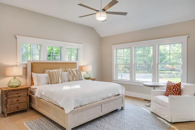 a bedroom with a large bed and a large window
