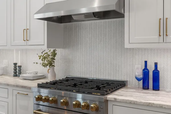 a kitchen with stove and cabinets