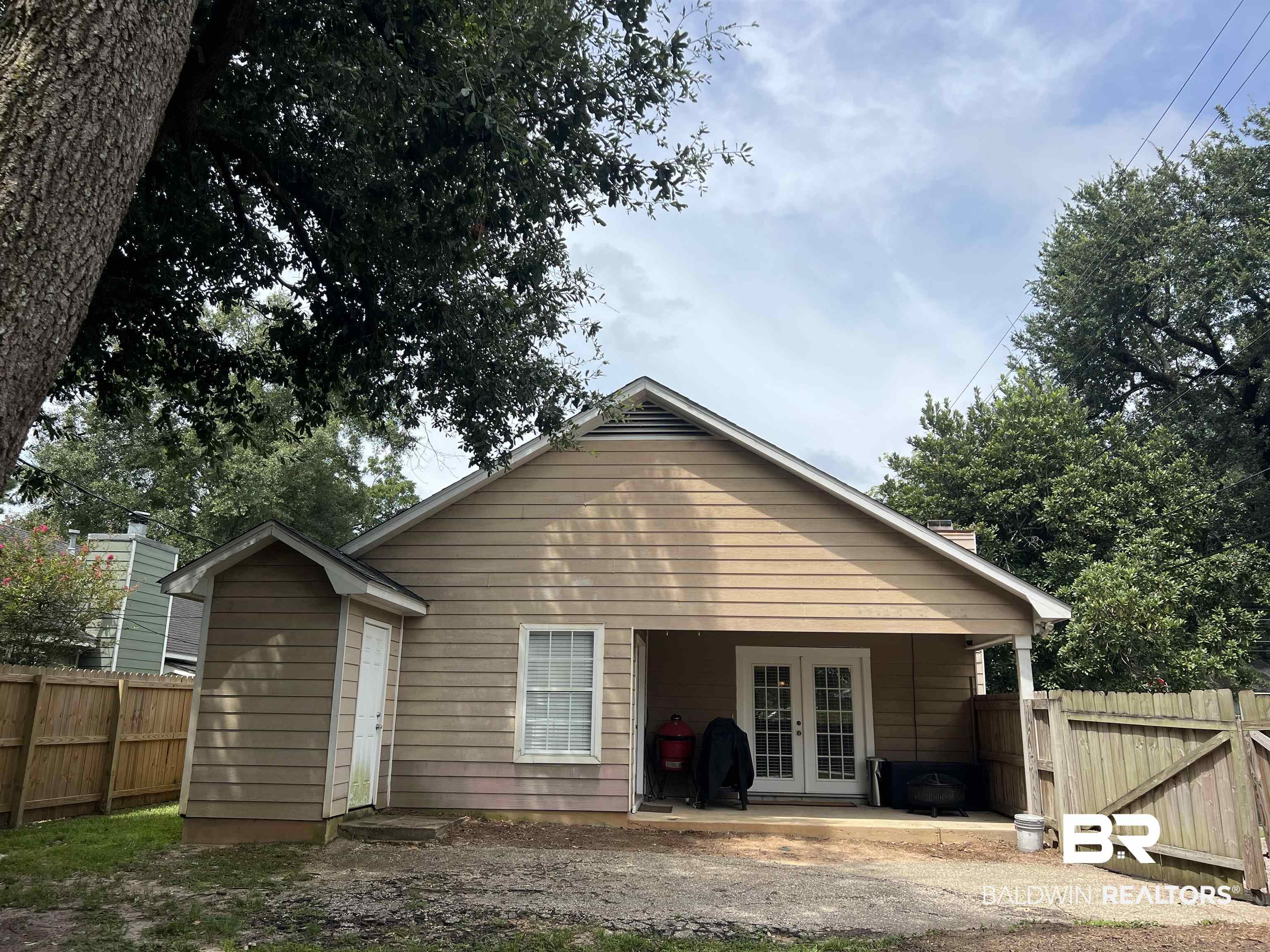 51 Bishop Lane South Mobile, AL 36608 - Photo 19 of 19 Back of property featuring french doors, a patio area, and a gate