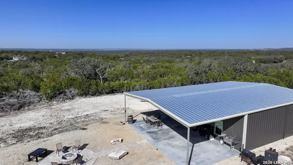 an aerial view of a house with a yard