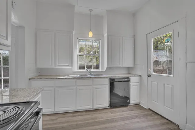 a kitchen with a sink stove and cabinets