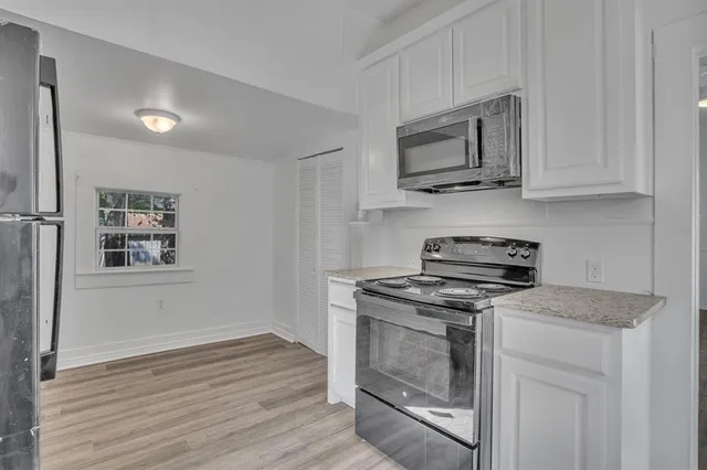 a kitchen with a stove and a microwave