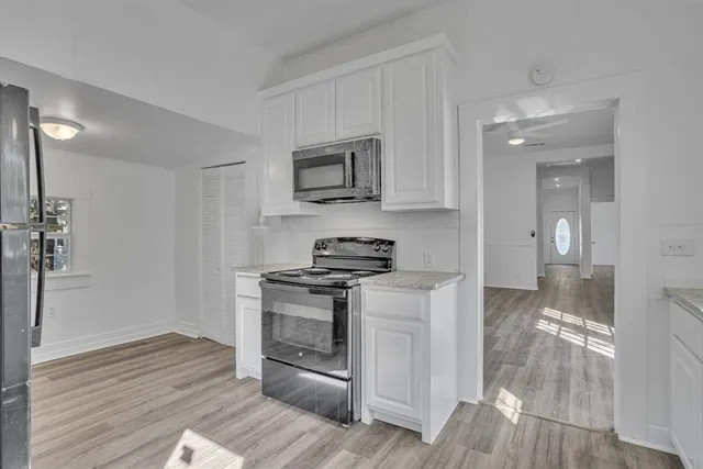 a kitchen with stainless steel appliances granite countertop a stove and a refrigerator