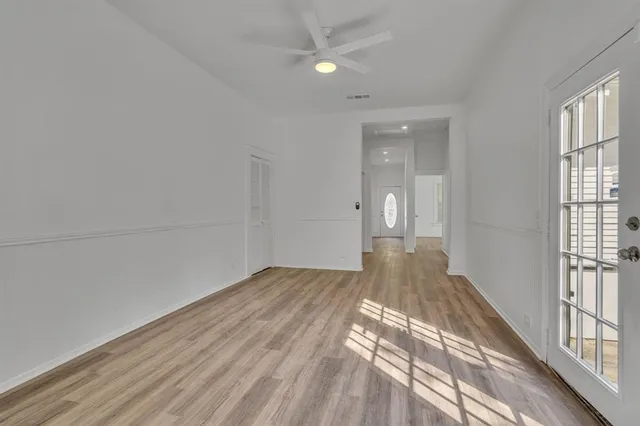 a view of a room with wooden floor and a window