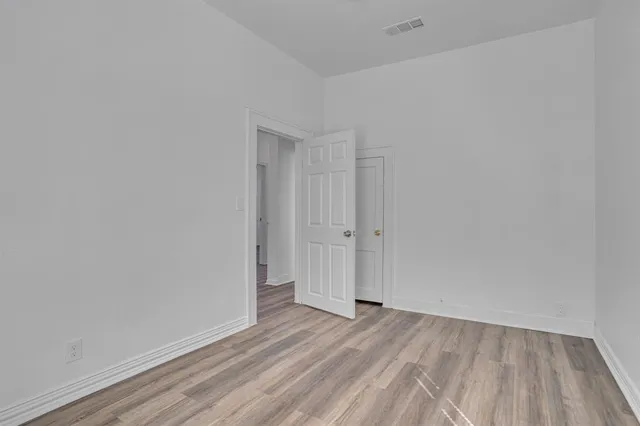 a view of an empty room and wooden floor