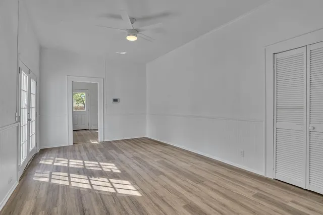 wooden floor in an empty room with a window