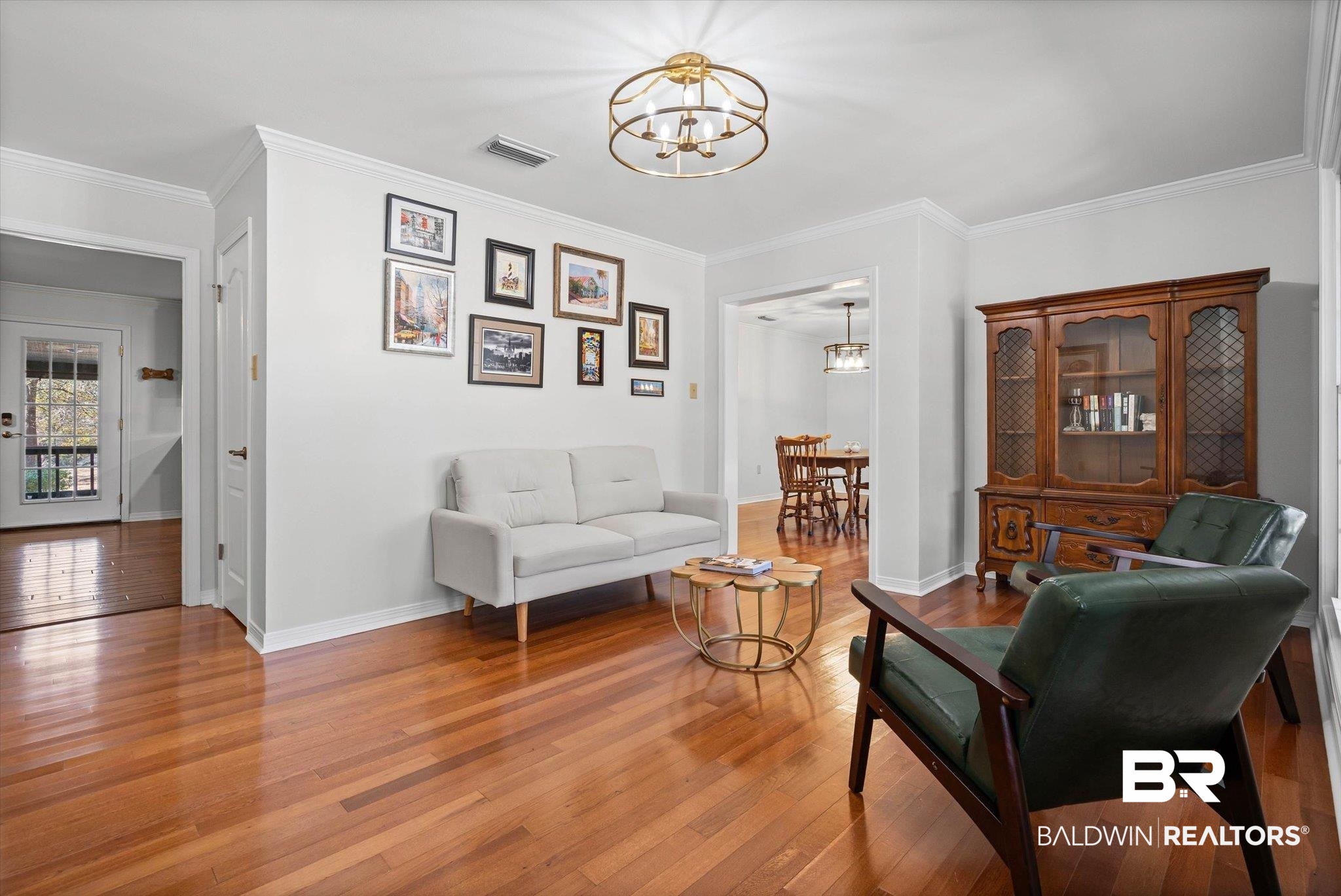 31369 Blakeley Way Daphne, AL 36527 - Photo 2 of 38 Living area featuring a chandelier, ornamental molding, and wood-type flooring