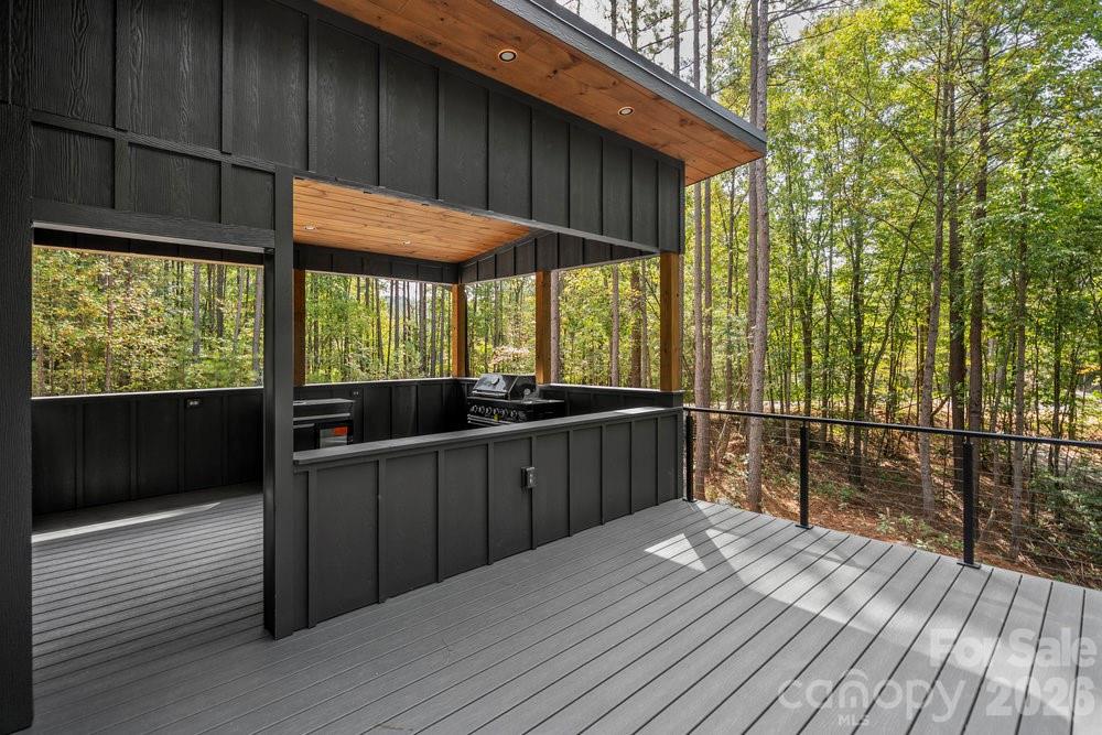 203 Golden Crk Ridge Union Mills, NC 28167 - Photo 14 of 47 a view of a balcony with wooden floor and iron stairs